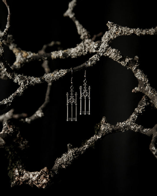 Close-up of the antiqued silver graveyard gate charm on the Cemetery Walks earrings, The Pretty Cult