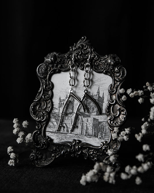 Silver scythe drop earrings shown as a pair, The Pretty Cult