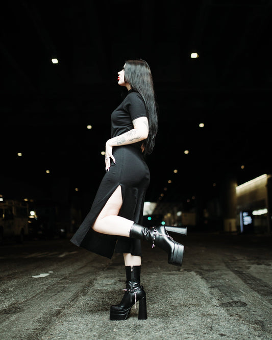 Black stretch cotton midi dress worn with boots