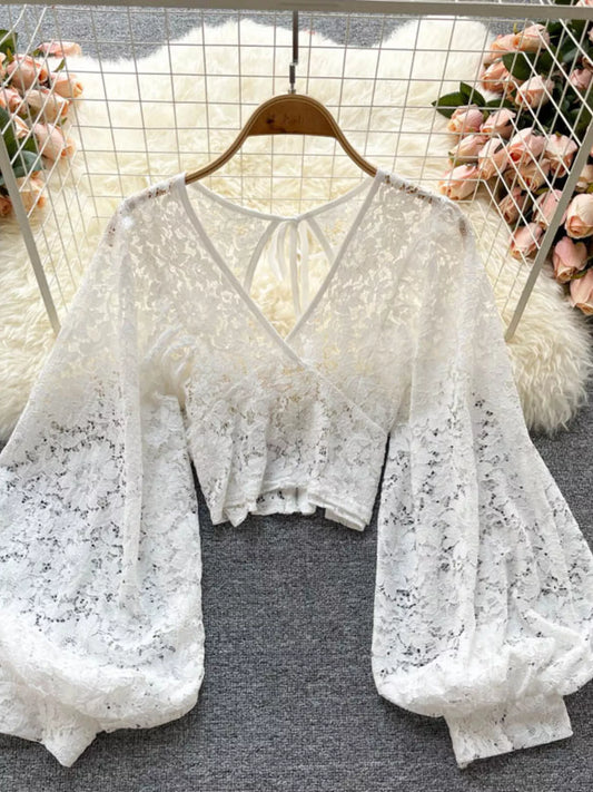 Lace tie-back long-sleeve top in white by Pinup Girl Clothing.