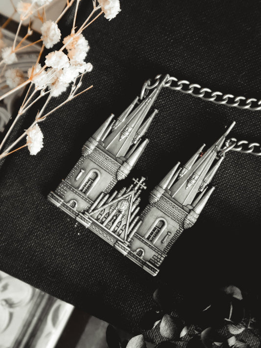 Model wearing the Tyn Cathedral antique silver cathedral pendant