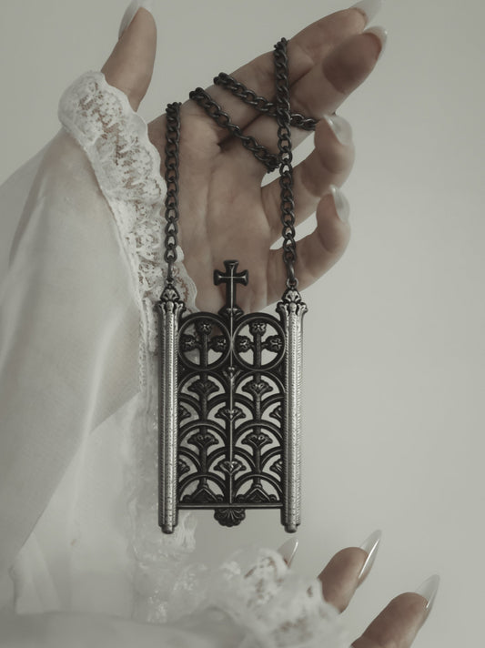 Model wearing the Rotunda Relic antique silver gate pendant
