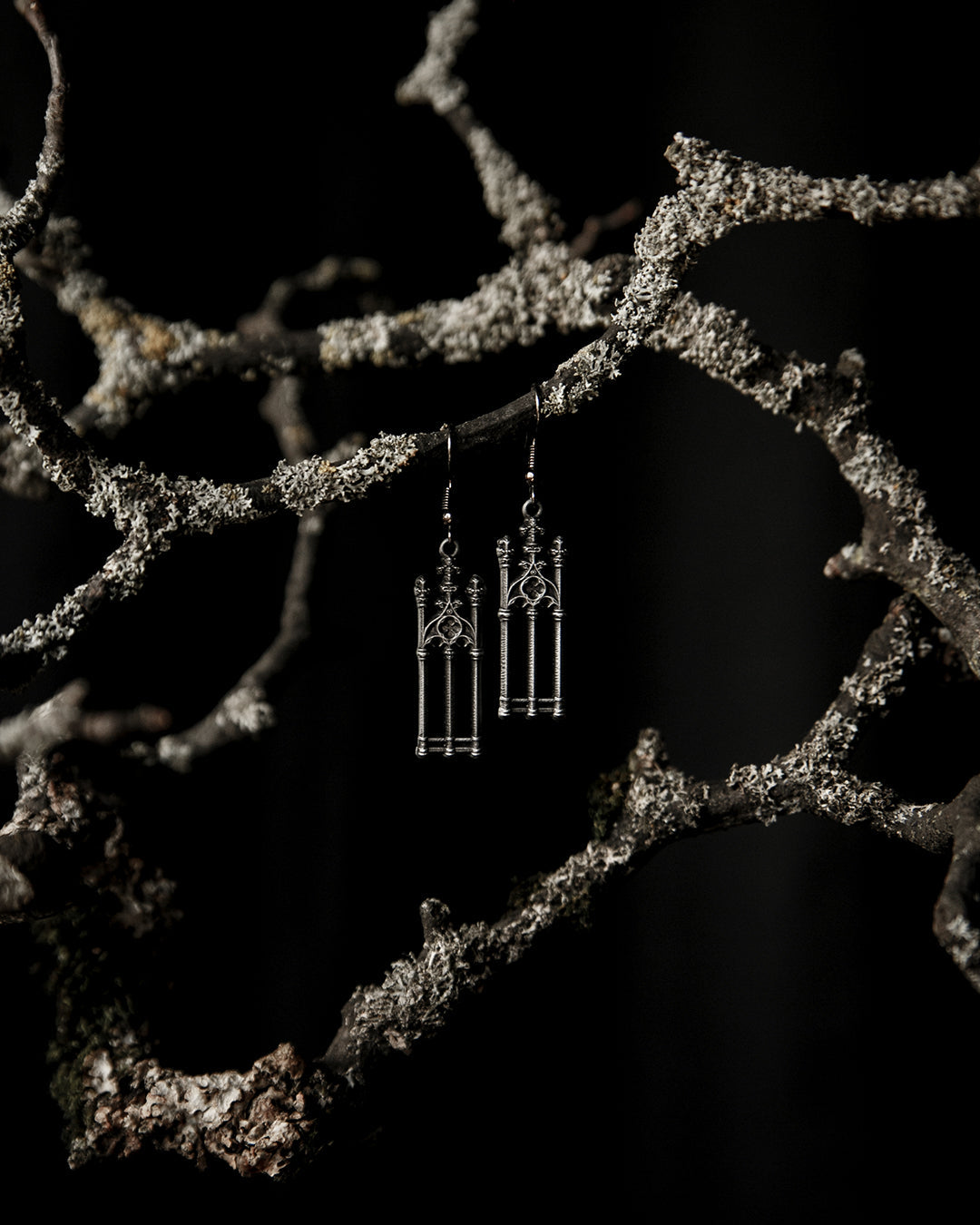 Close-up of the antiqued silver graveyard gate charm on the Cemetery Walks earrings, The Pretty Cult