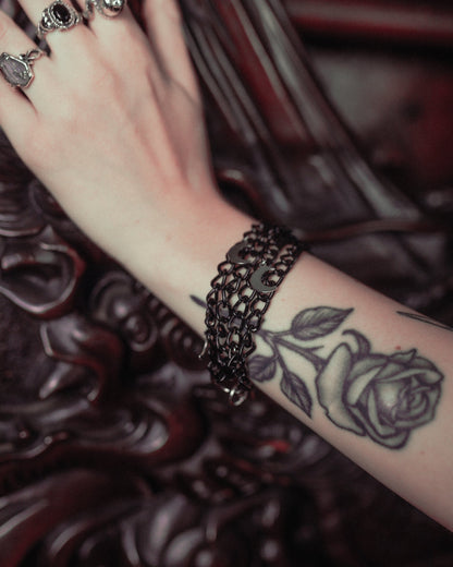 Close up of the Winter Moon black four tier chain bracelet with crescent moons