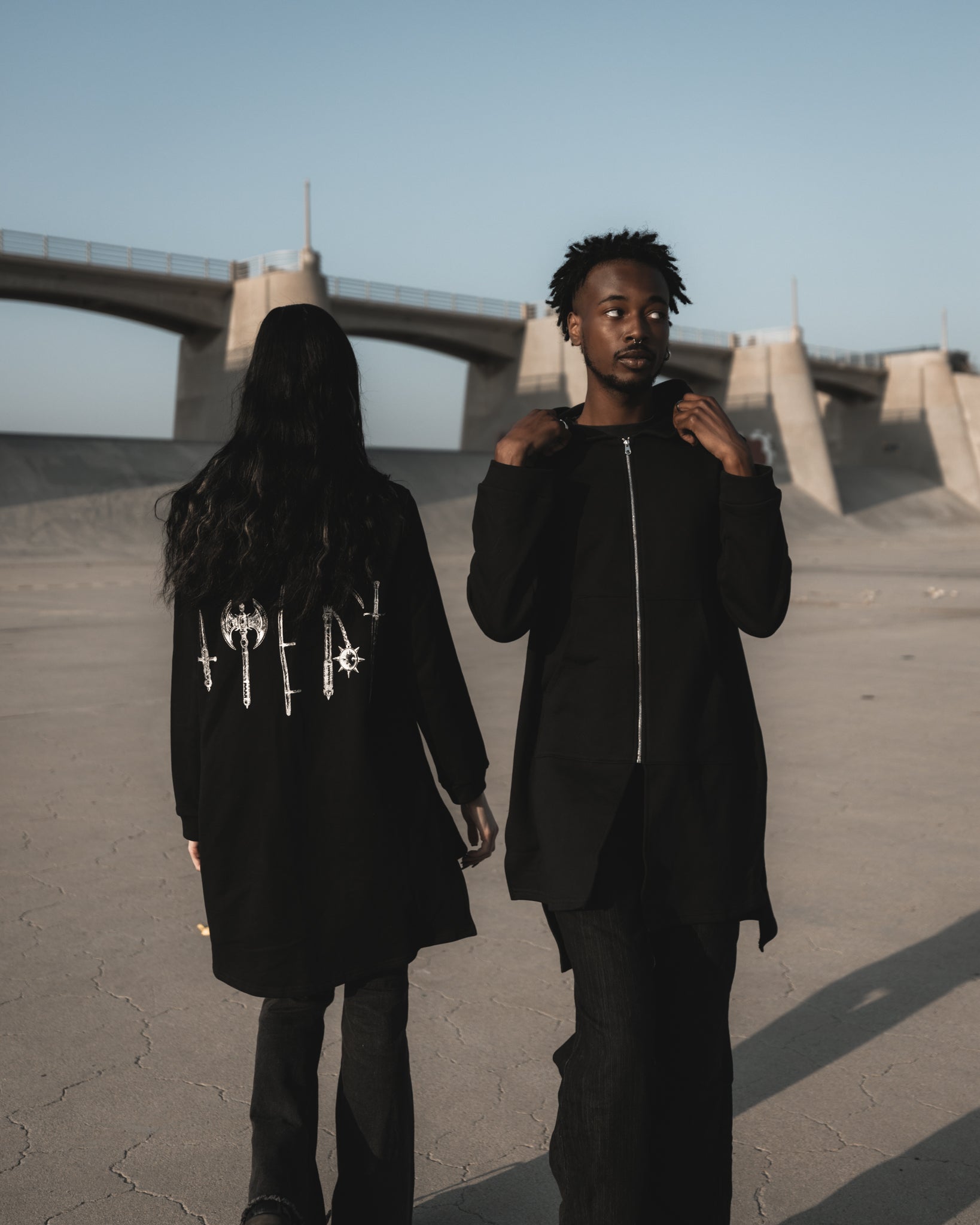Black longline zip hoodie with metallic silver weapons print on the back