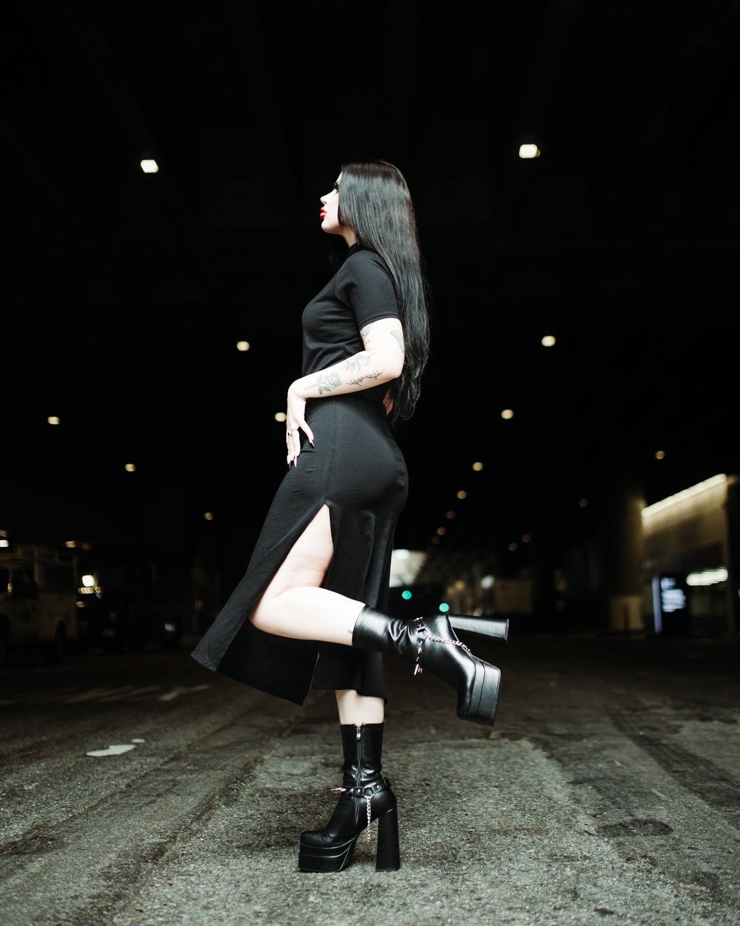 Black stretch cotton midi dress worn with boots