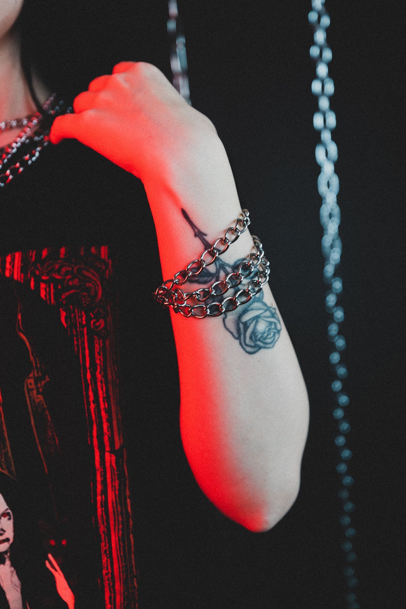 Close up of the Evil Things silver chain bracelet on the wrist