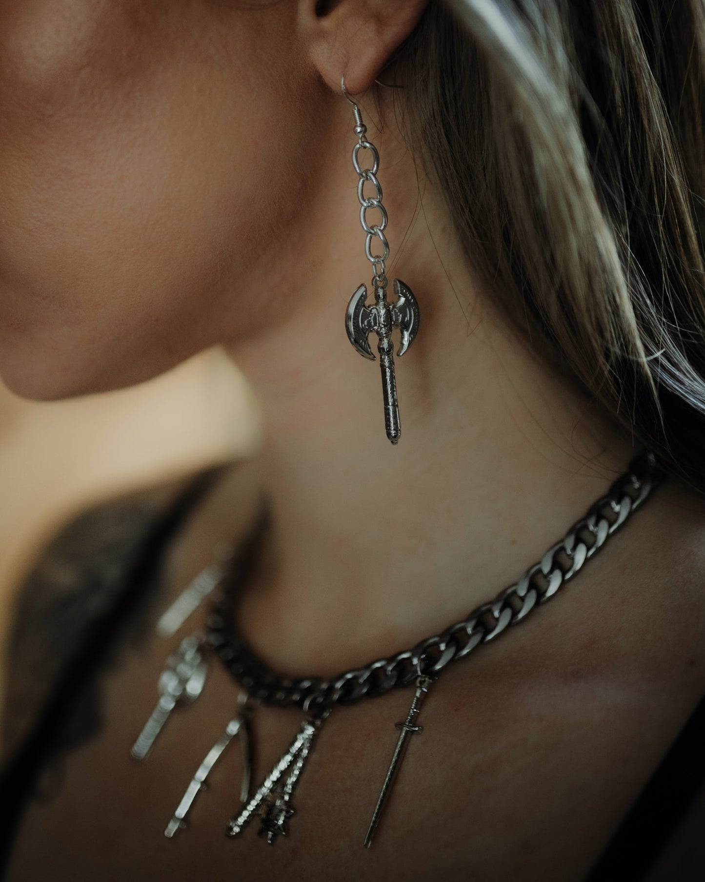 Model wearing the silver Beserker battle axe drop earrings, The Pretty Cult
