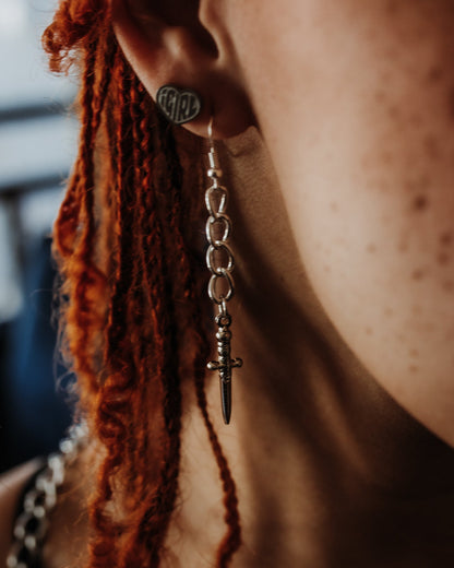Athame silver dagger earrings styled against a dark background, The Pretty Cult