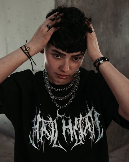 Model wearing the Covet silver layered chain necklace with a black top
