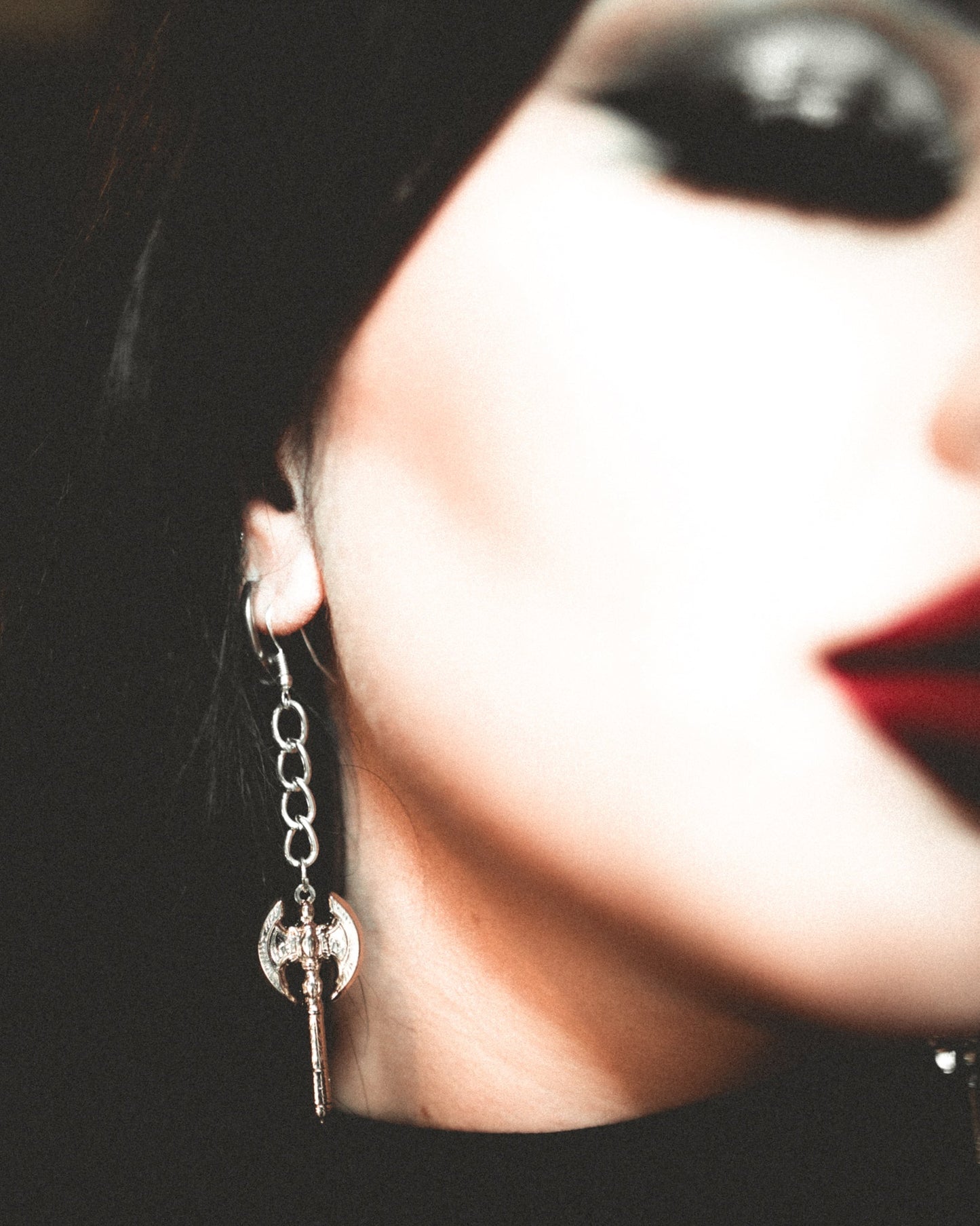 Beserker silver battle axe earrings shown against a dark background, The Pretty Cult