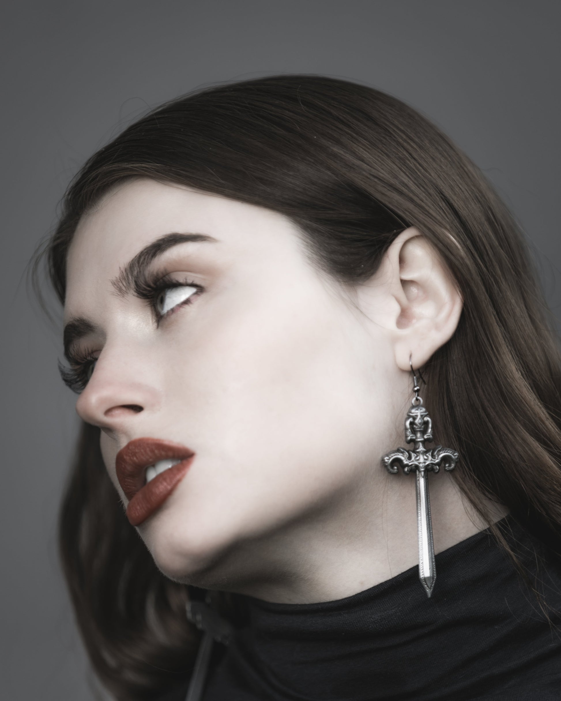 Close-up of the antiqued silver sword charm on the Woe Blade earrings, The Pretty Cult