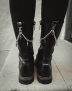 Silver crescent moon boot charm chain clipped to a black combat boot