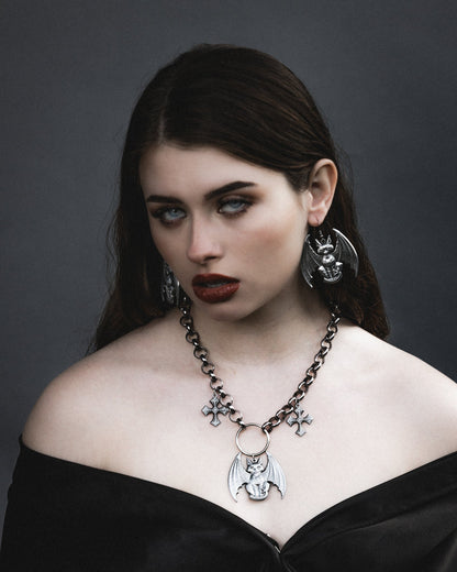 Close up of the Lethal silver gargoyle pendant and medieval crosses