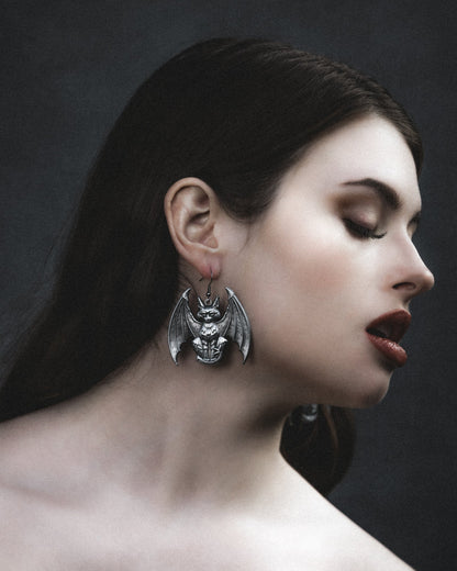 Lethal silver gargoyle cat earrings worn with dark hair, The Pretty Cult