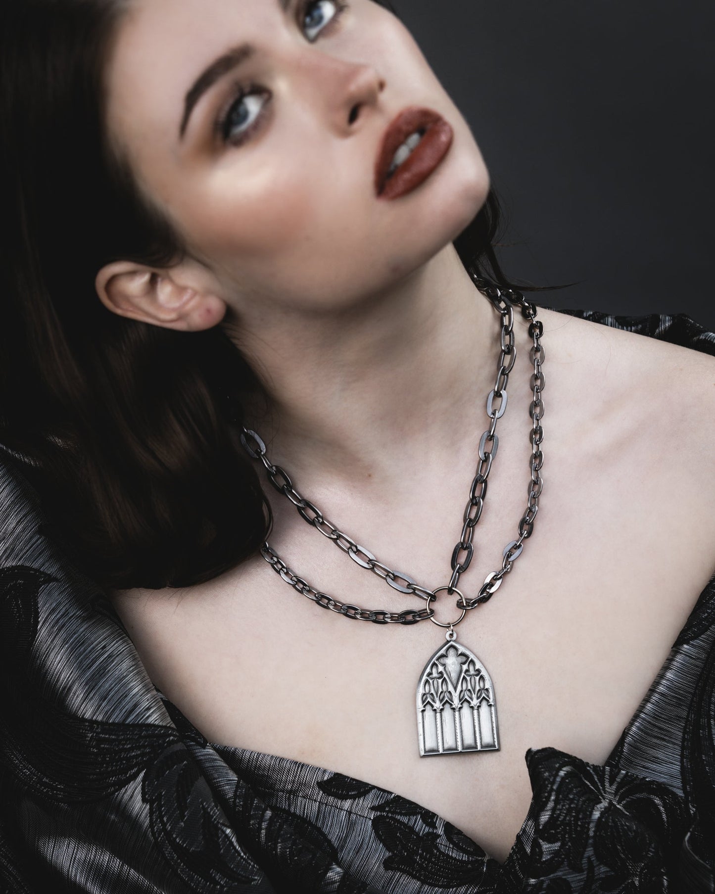 Close up of the Dark Sacrament silver gothic window pendant