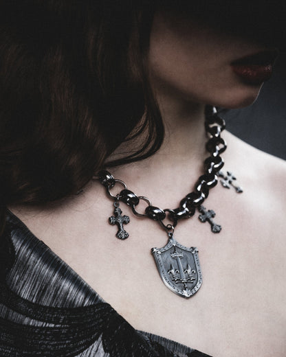 Model wearing the Le Fay silver shield and medieval cross necklace