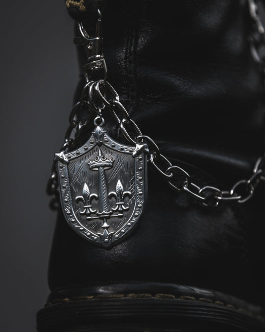 Silver Le Fay shield boot chain clipped to a black combat boot