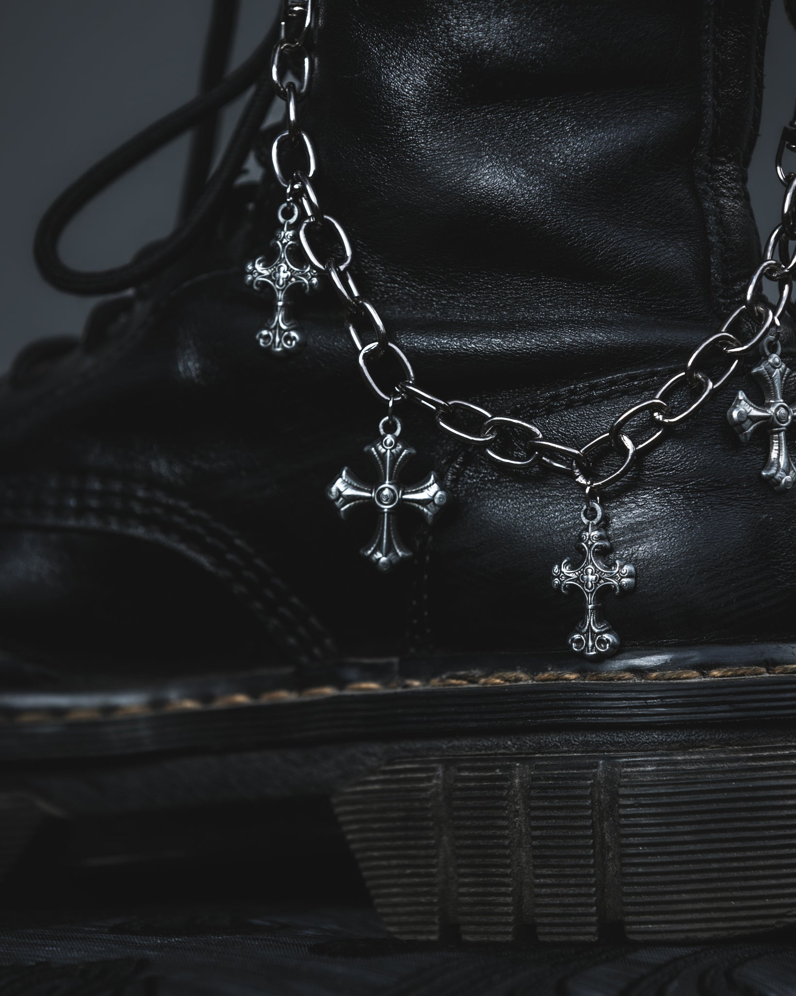 Silver Silent Vow cross boot chain clipped to a black combat boot