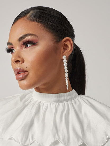 Faux pearl drop earrings in white by Pinup Girl Clothing.