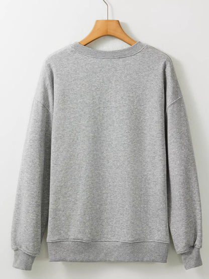 Detail of the ribbed crewneck collar on the gray Boo Crew sweatshirt