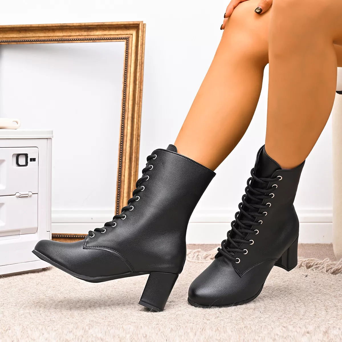 Victoria lace-up block heel granny boots in black, worn seated