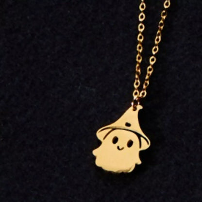 Gold ghost pendant necklace worn at the collarbone