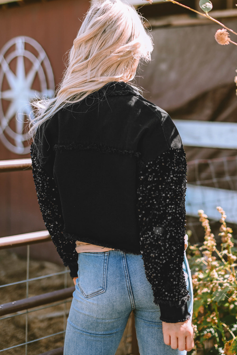 Close-up of the sequin sleeve on the Rare Tour black denim jacket
