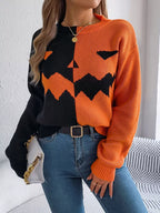 Carved two-tone pumpkin face sweater in black and orange