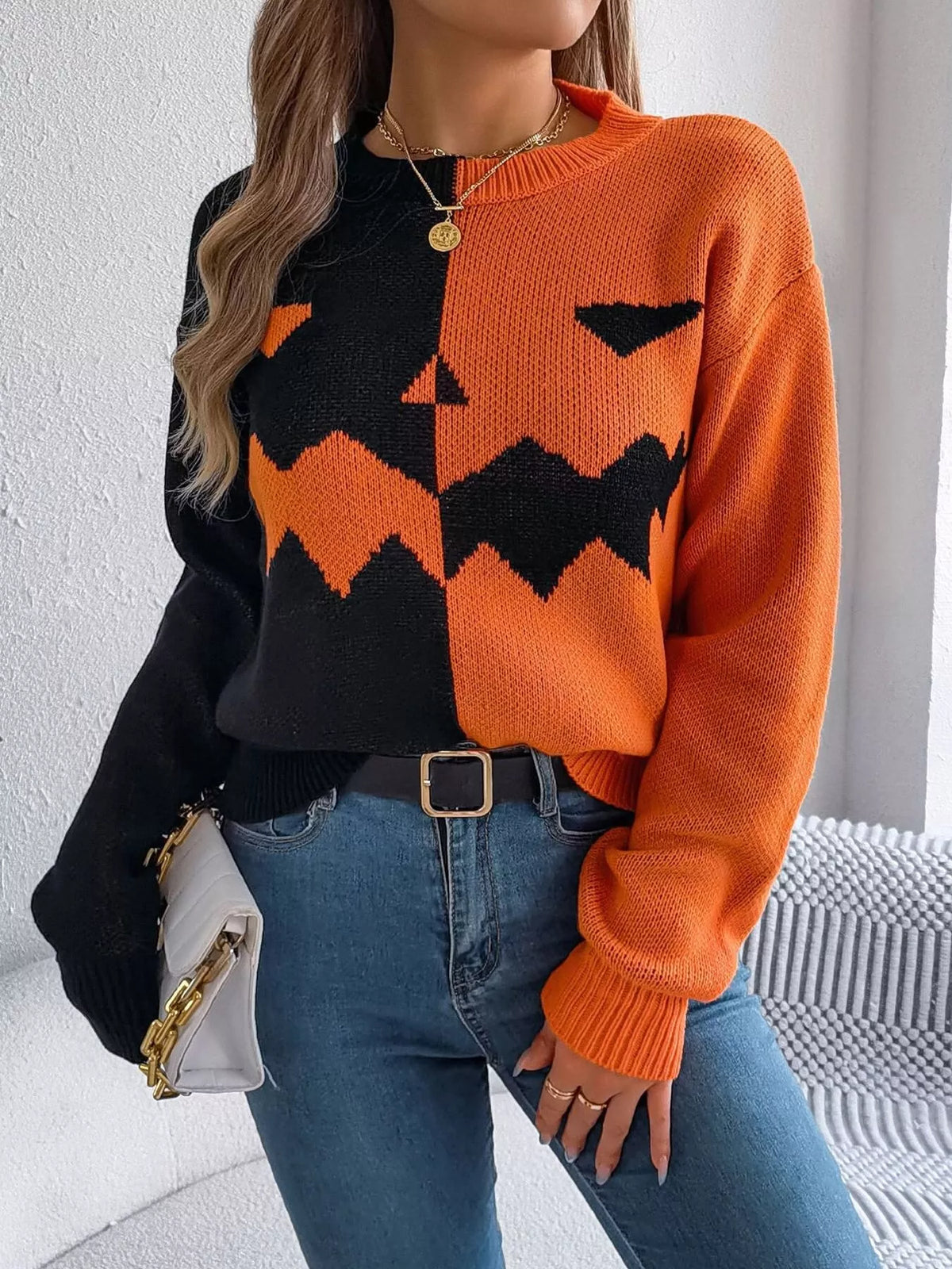 Carved two-tone pumpkin face sweater in black and orange
