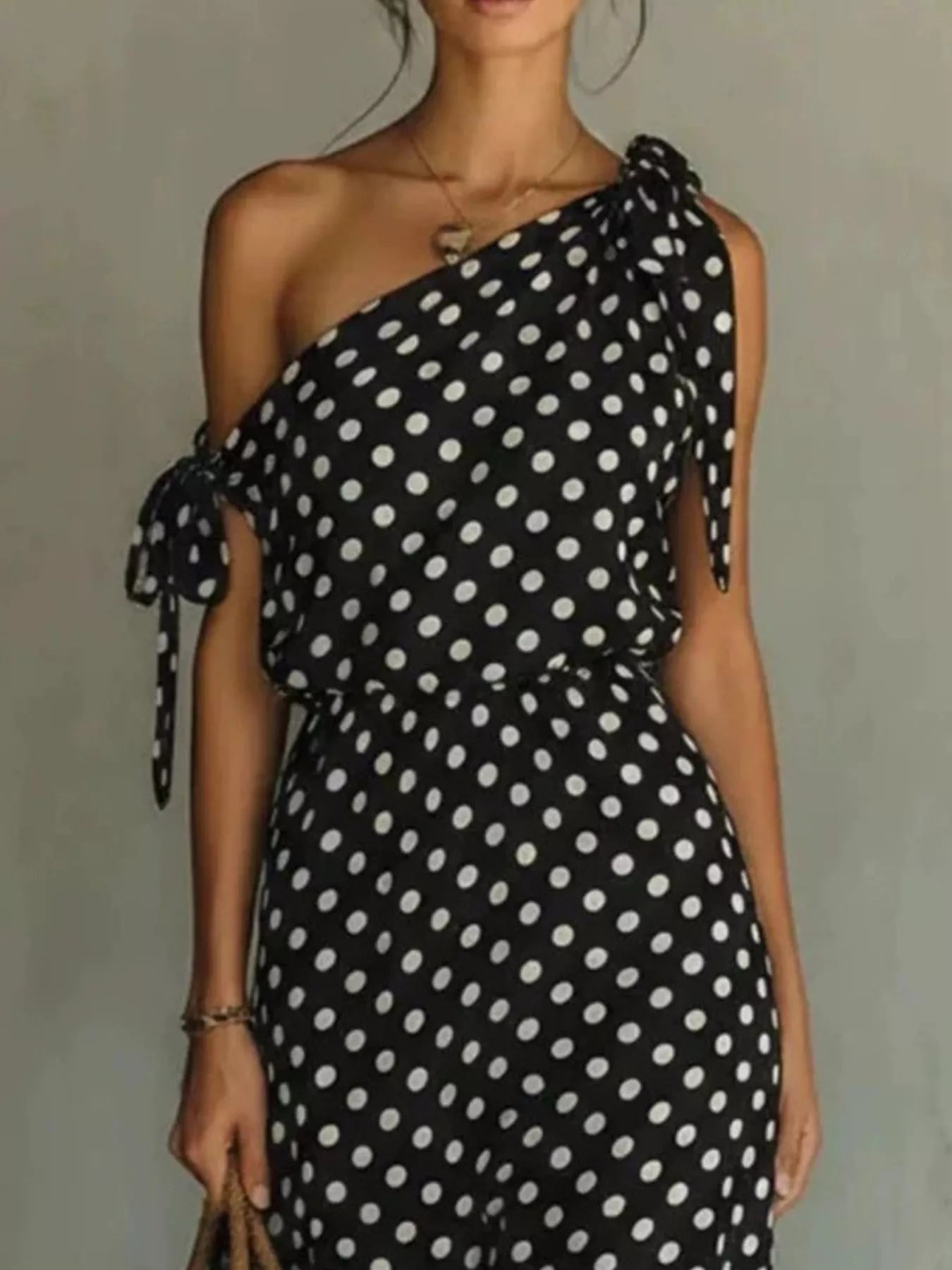 Close detail of the bow tie shoulder on the Dorothea polka dot midi dress, by Pinup Girl Clothing