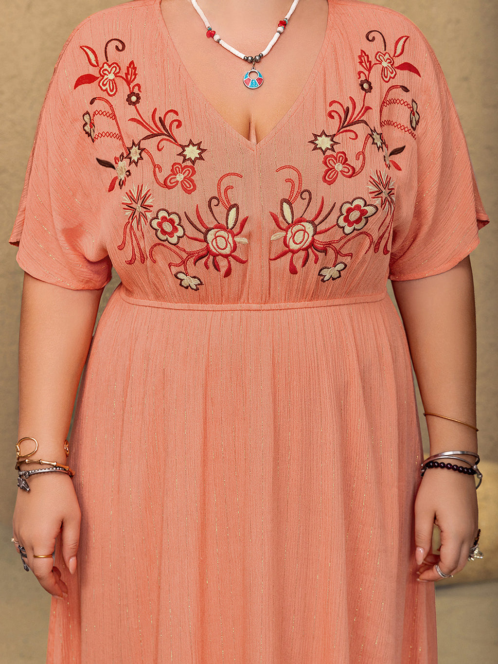 Close up of the red and cream floral embroidery on the Frolic coral maxi dress bodice