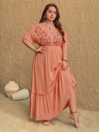 Frolic coral maxi dress held out to show the ruffled tiered skirt