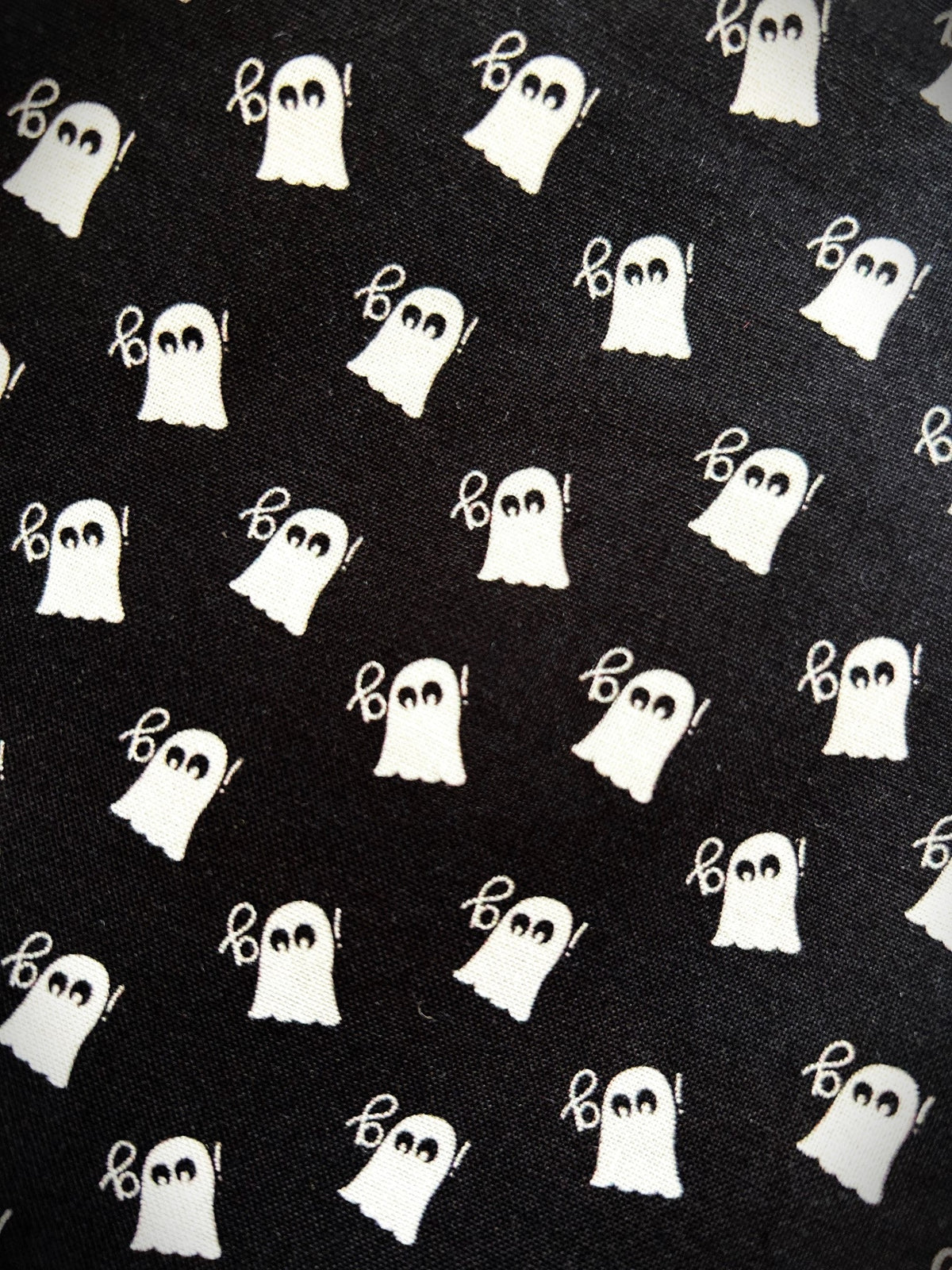 Close up of the white ghost print on the black cotton Mini Ghosts skater skirt