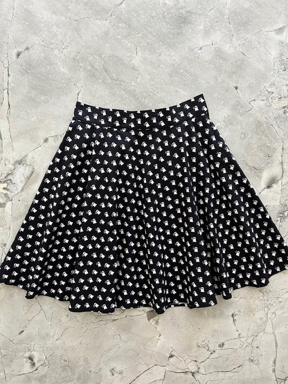 Black and white Mini Ghosts skater skirt with a white ghost print on black cotton, laid flat