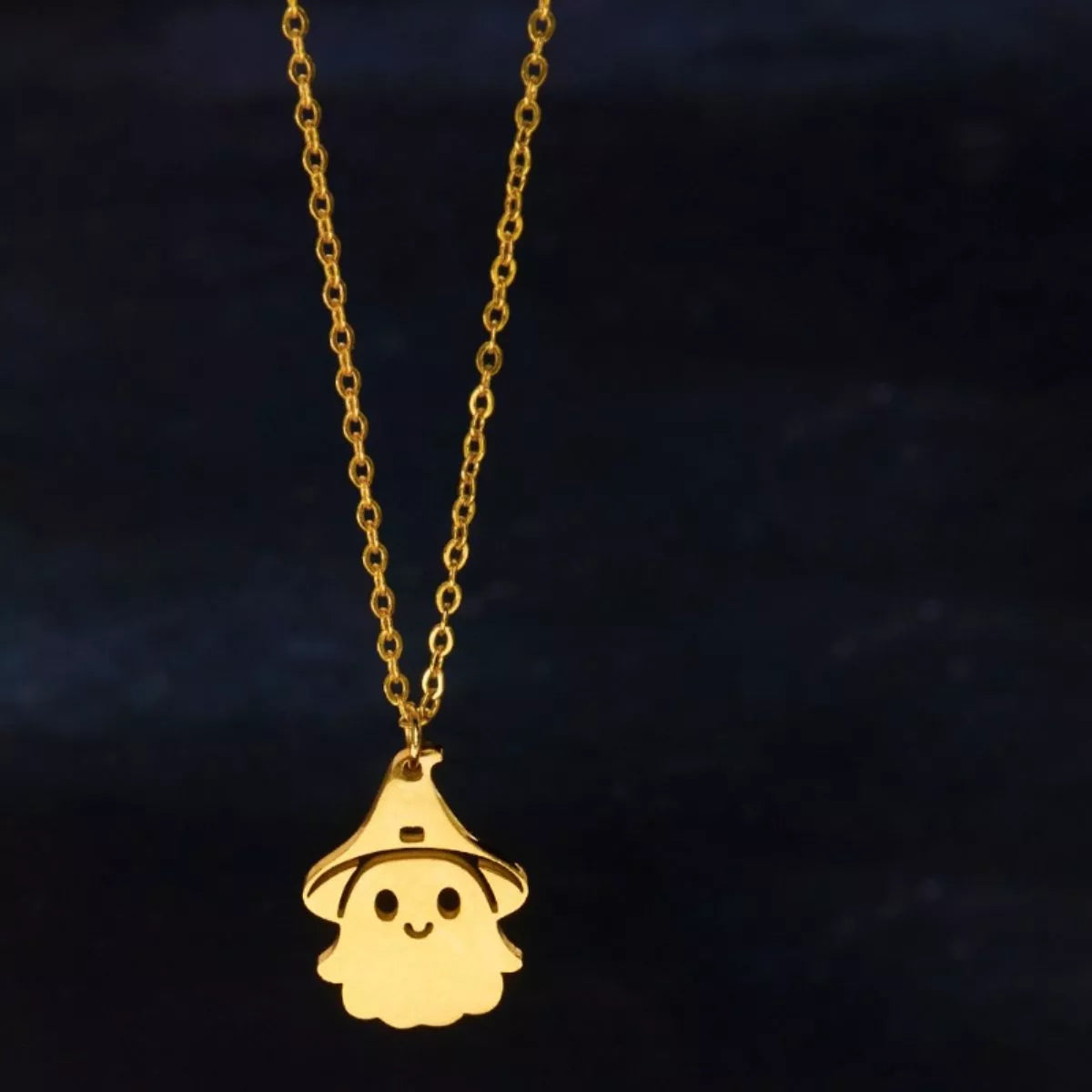 Gold ghost pendant necklace shown on the chain with extender