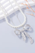 Zoe pearl necklace and bow earrings set in silver by Pinup Girl Clothing.