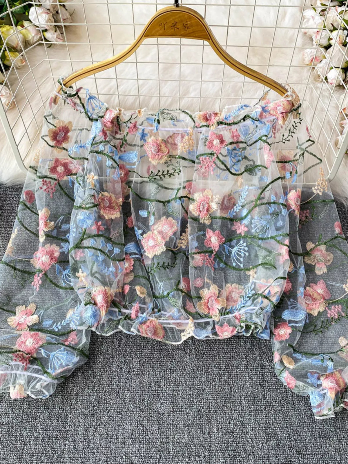 Floral embroidered mesh off-shoulder top in light blue by Pinup Girl Clothing.