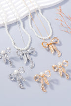 Zoe synthetic pearl necklace and bow earrings set by Pinup Girl Clothing, in silver or gold.