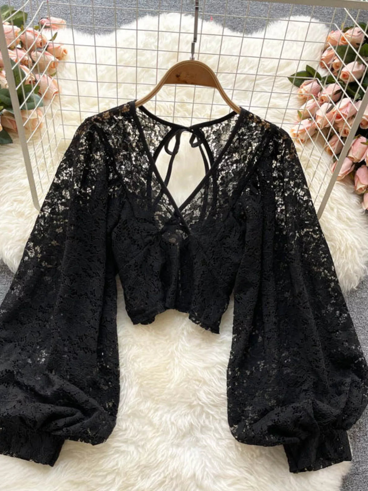 Lace tie-back long-sleeve top in black by Pinup Girl Clothing.