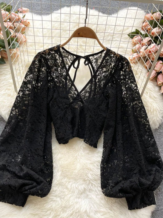 Lace tie-back long-sleeve top in black by Pinup Girl Clothing.