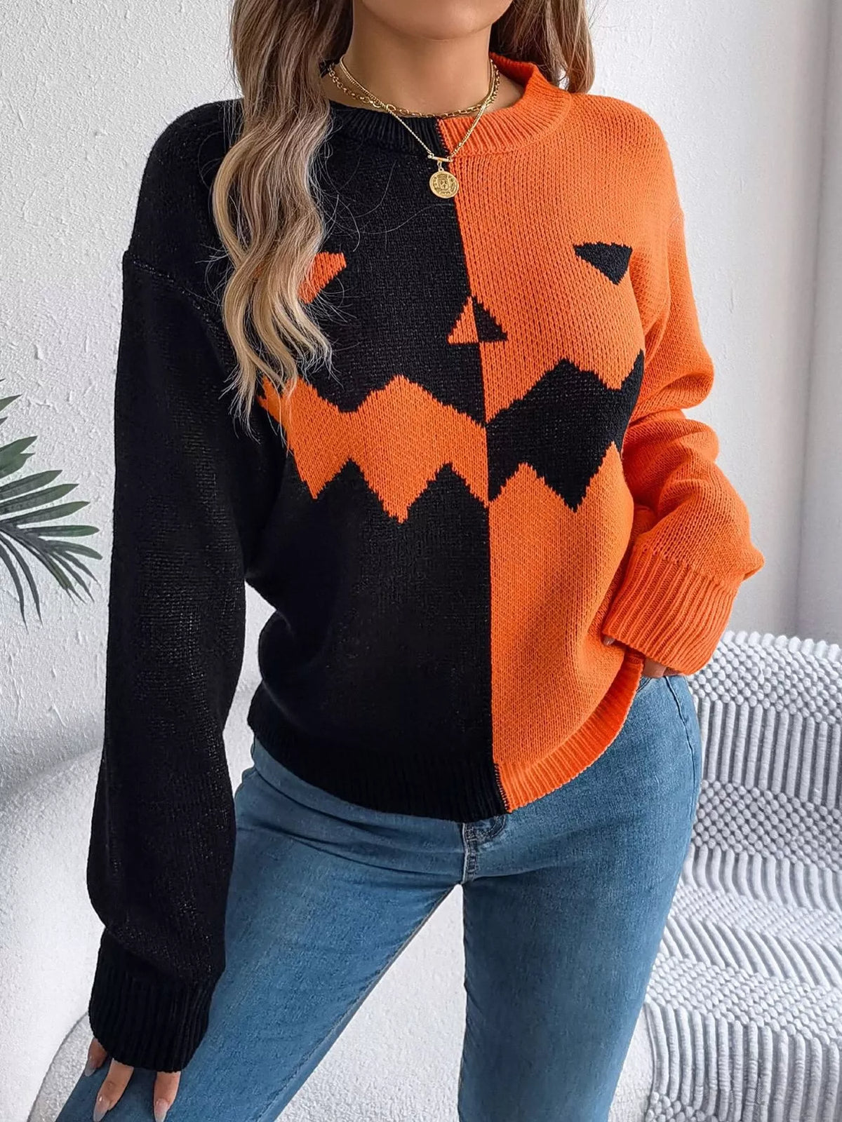 Carved two-tone pumpkin face sweater in black and orange