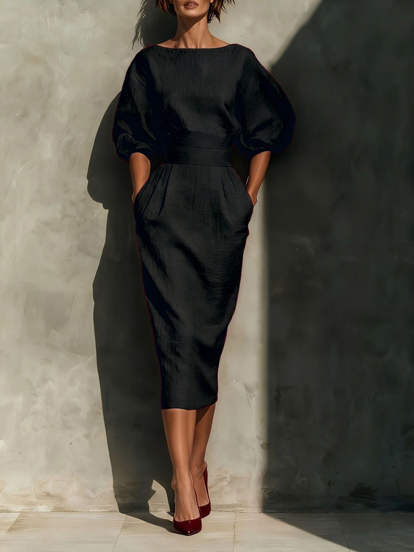 Puff-sleeve pencil midi dress in black by Pinup Girl Clothing, with pockets.