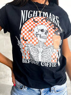Close-up of the checkerboard skeleton print on the black graphic tee