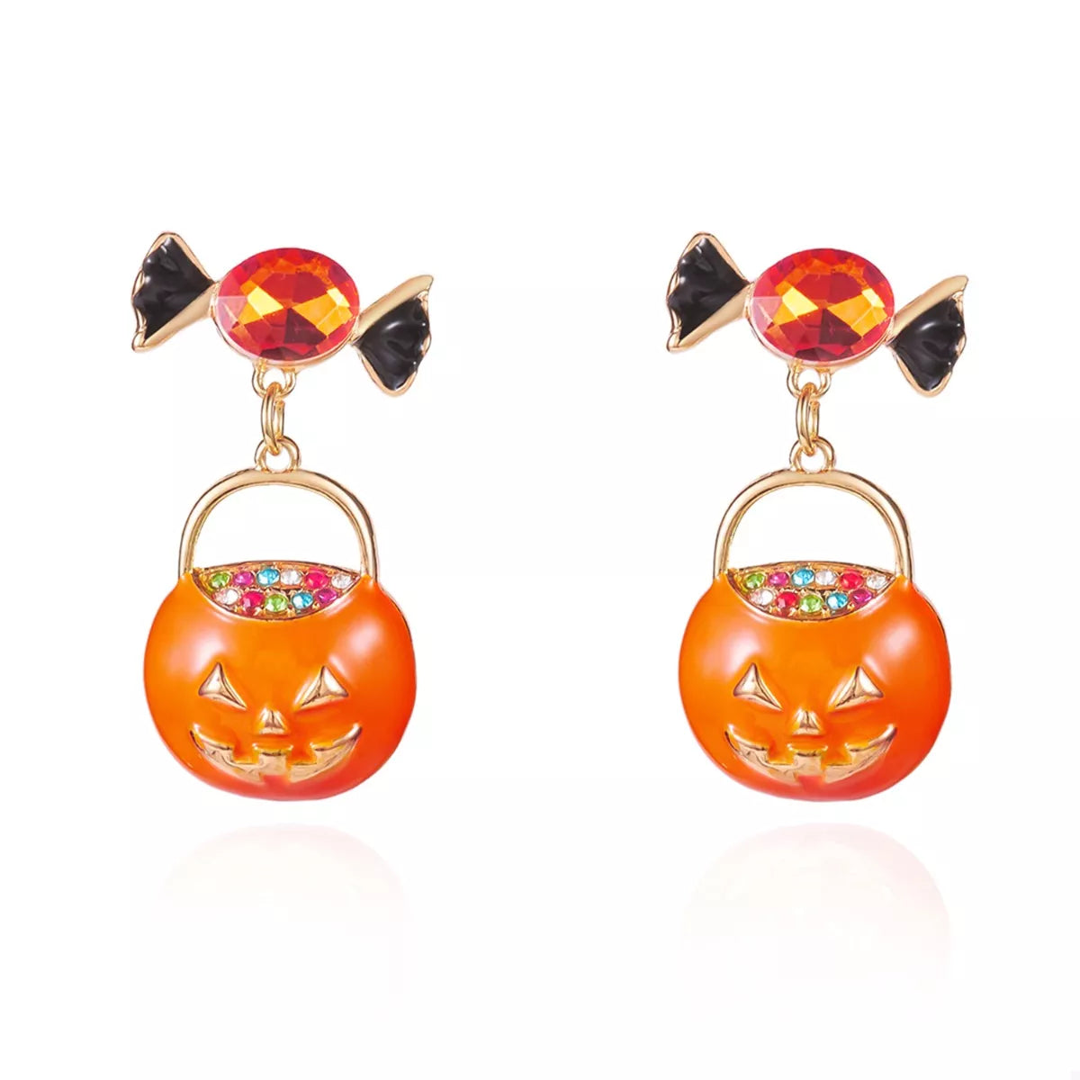 Pair of orange pumpkin rhinestone earrings laid flat