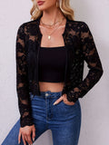 Model wearing the black sheer floral lace open front jacket over a black crop top with high-waisted jeans, front view