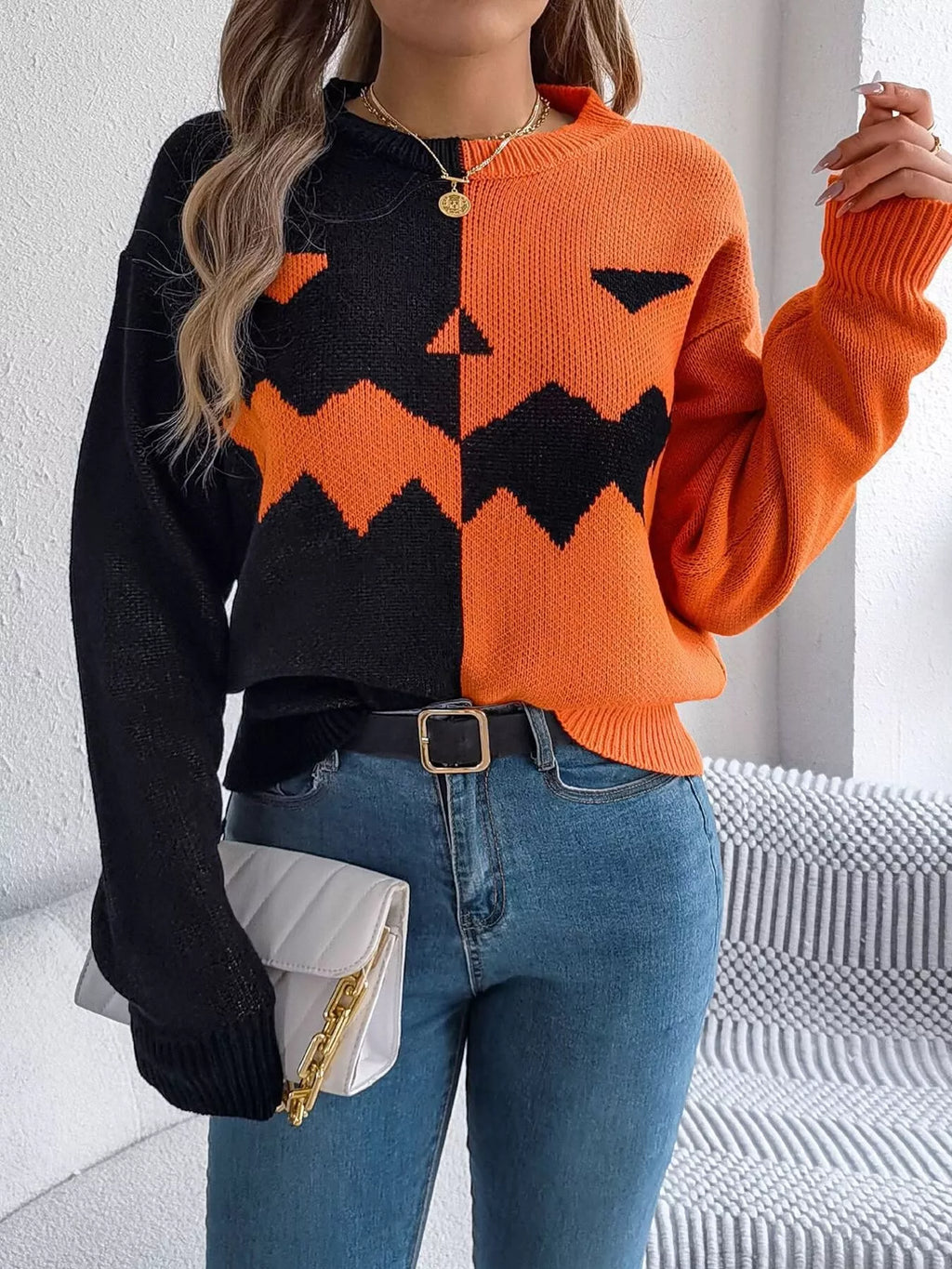 Carved two-tone pumpkin face sweater in black and orange
