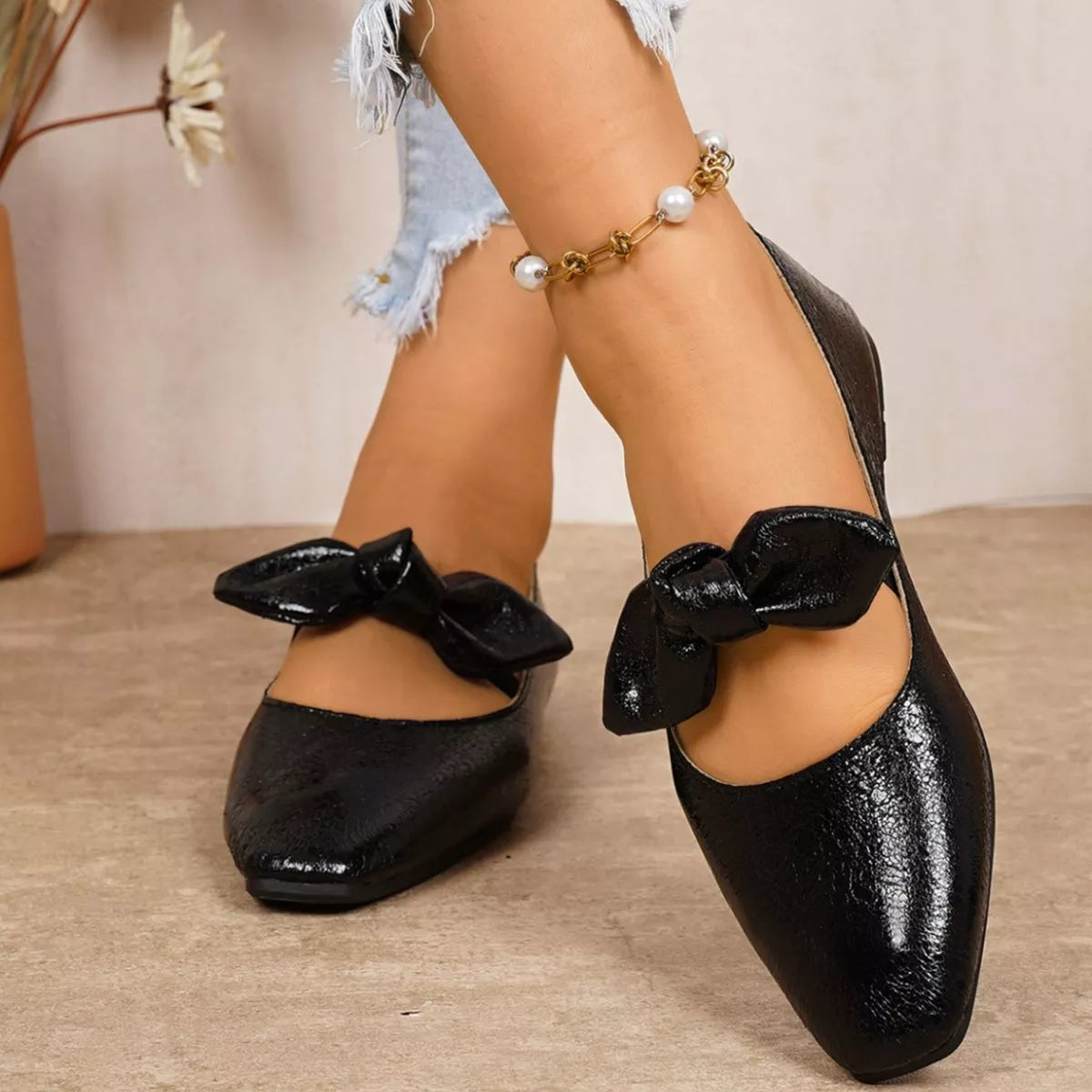 Bow square-toe slip-on flats in black by Pinup Girl Clothing.