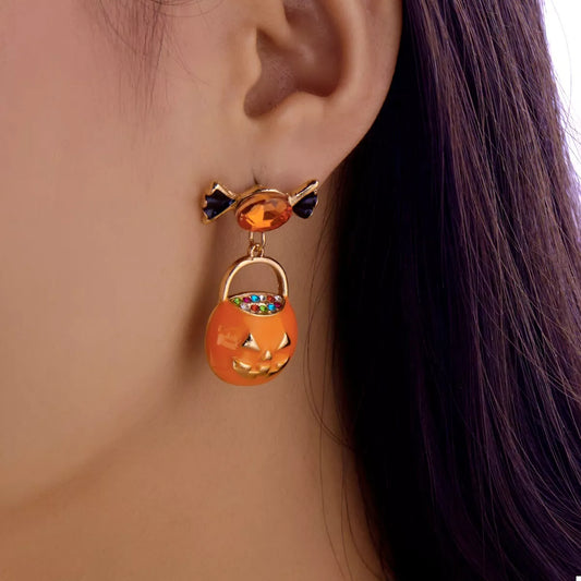 Orange rhinestone pumpkin drop earrings, close-up of the pave stones