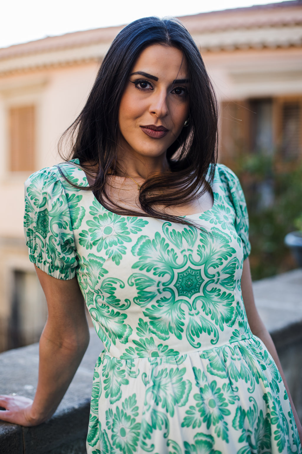 Model in the Amara swing dress in green and white Noto Tile print, with puff sleeves and a full swing skirt, by Pinup Girl Clothing